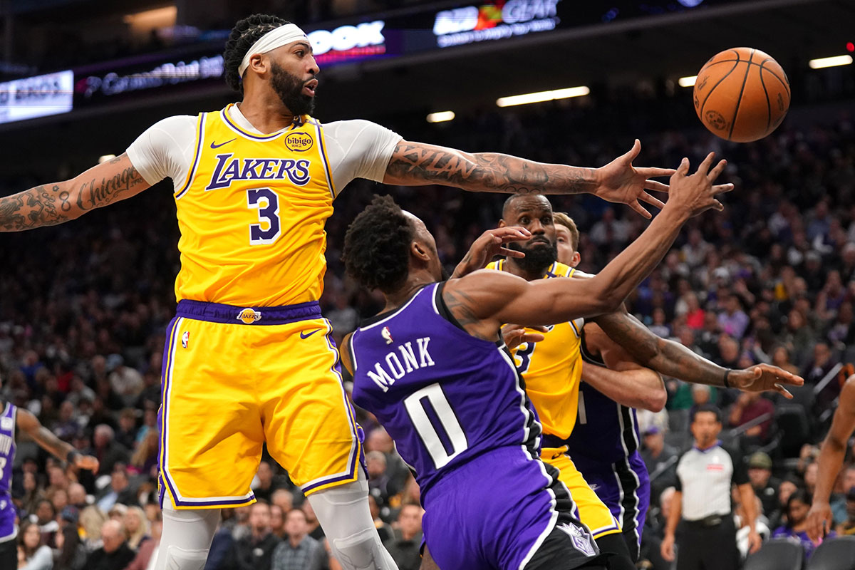 Sacramento Kings guard Malik Monk (0) loses control of the ball next to Los Angeles Lakers forward Anthony Davis (3) in the third quarter at the Golden 1 Center.