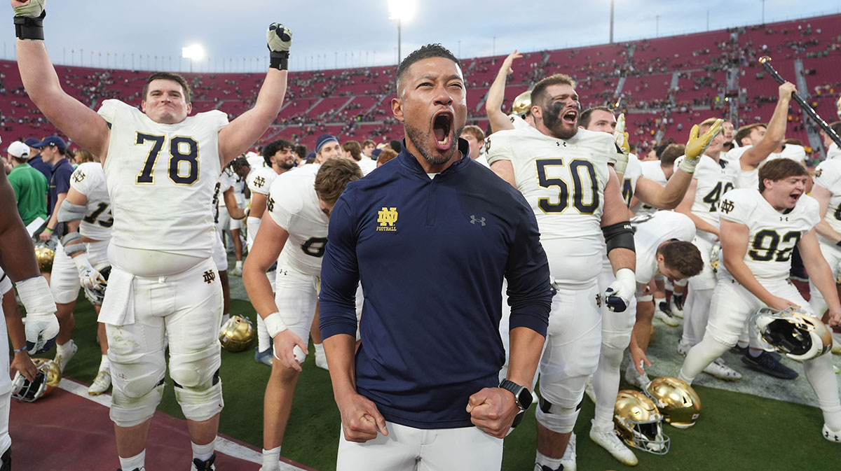 Notre Dame Fighting Irish head coach Marcus Freeman celebrates with players at the end of the game against the Southern California Trojans at United Airlines Field at Los Angeles Memorial Coliseum.