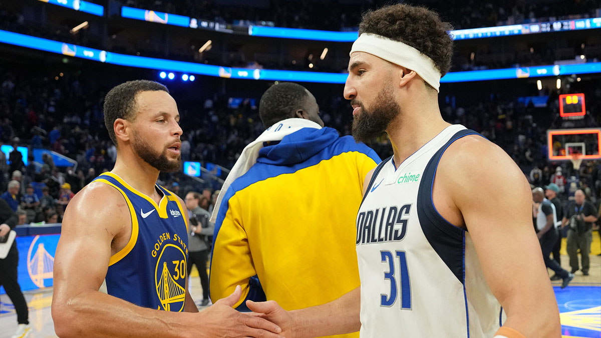 Warriors guard Stephen Curry (30) and Dallas Mavericks guard Klay Thompson (31) greet each other after the game at Chase Center