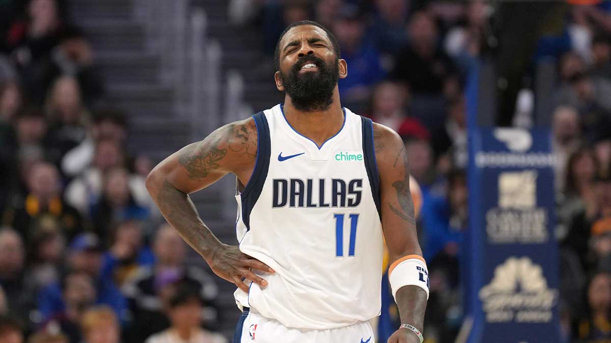 Mavericks guard Kyrie Irving (11) reacts after suffering an injury during the fourth quarter against the Golden State Warriors at Chase Center