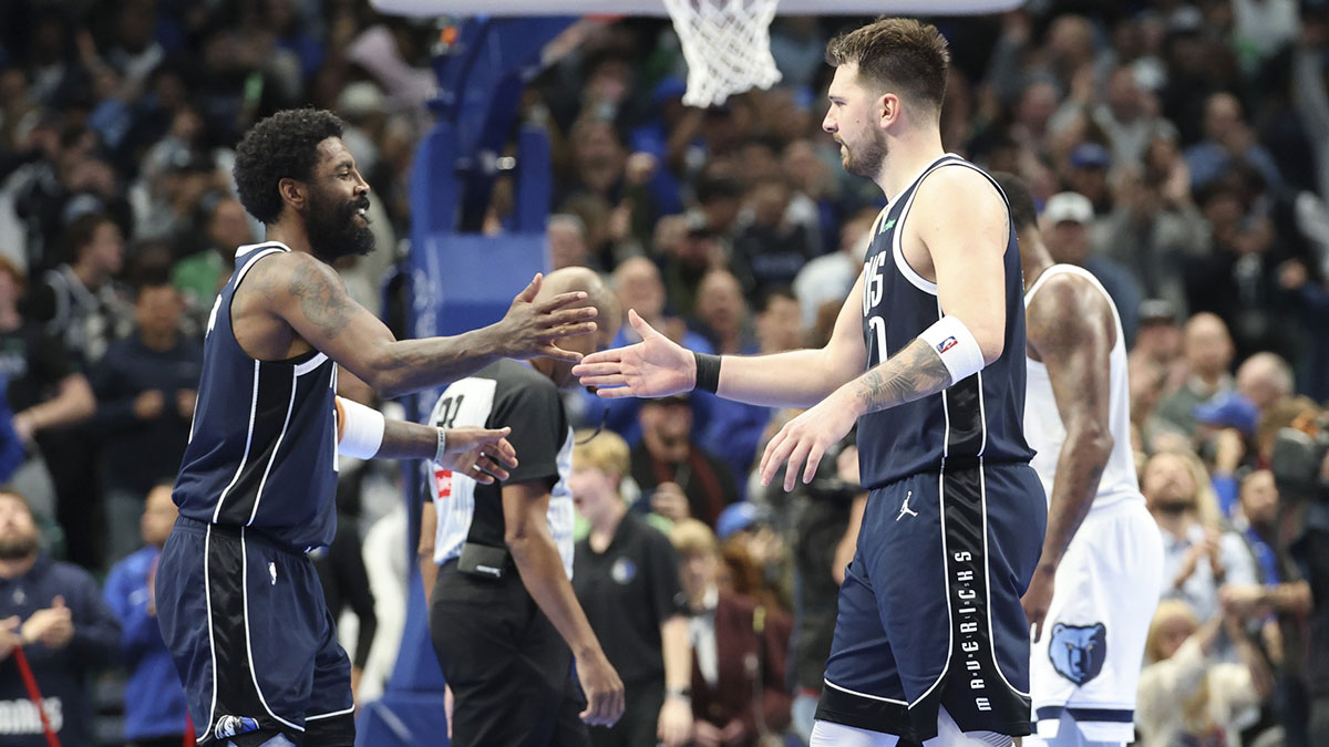 Mavericks guard Kyrie Irving (11) celebrates with Dallas Mavericks guard Luka Doncic (77) during the fourth quarter against the Memphis Grizzlies at American Airlines Center
