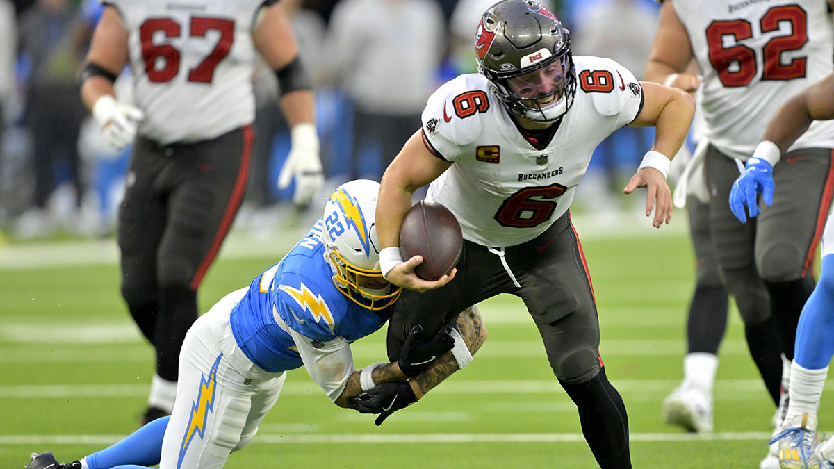 Tampa Bay Buccaneers quarterback Baker Mayfield (6) is stopped by Los Angeles Chargers cornerback Elijah Molden (22) in the second half at SoFi Stadium.