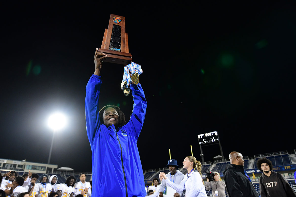 Miami Northwestern's Teddy Bridgewater raises the state trophy following the team's win over Raines in the Class 3A championship