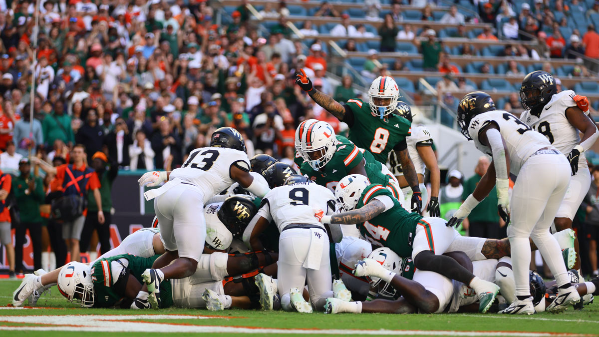 Miami Hurricanes quarterback Cam Ward (1) scores a touchdown against the Wake Forest Demon Deacons during the fourth quarter at Hard Rock Stadium.