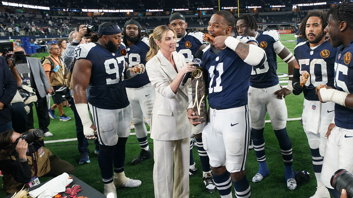 Dallas Cowboys linebacker Micah Parsons (11) stands with Madden Thanksgiving MVP trophy after defeating the New York Giants at AT&T Stadium.