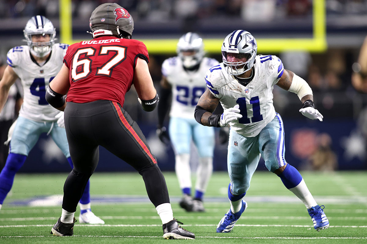 Dallas Cowboys linebacker Micah Parsons (11) rushes the passer against Tampa Bay Buccaneers offensive tackle Luke Goedeke (67) in the fourth quarter at AT&T Stadium.