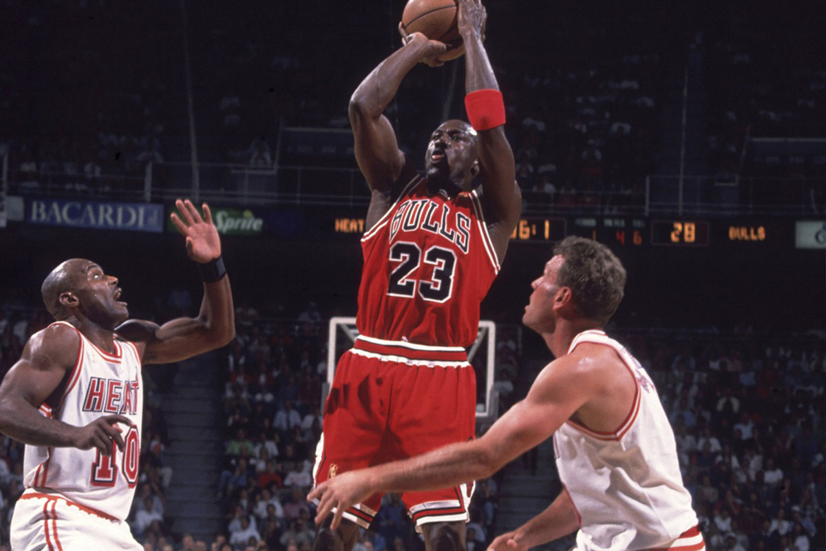 Chicago Bulls guard (23) Michael Jordan shoots between Miami Heat guards (10) Tim Hardaway and (8) Dan Marjele at the Miami Arena.