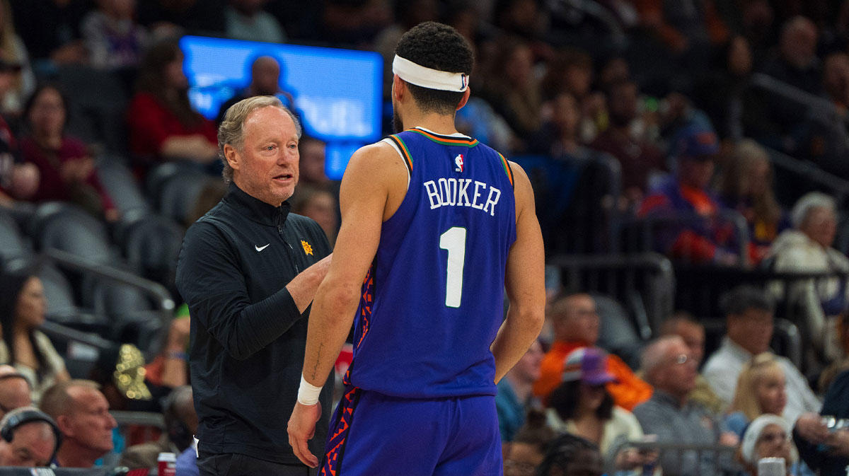 Phoenix Suns guard Devin Booker (1) and coach Mike Budenholzer between plays in the second half during a game against the Portland Trail Blazers at Footprint Center