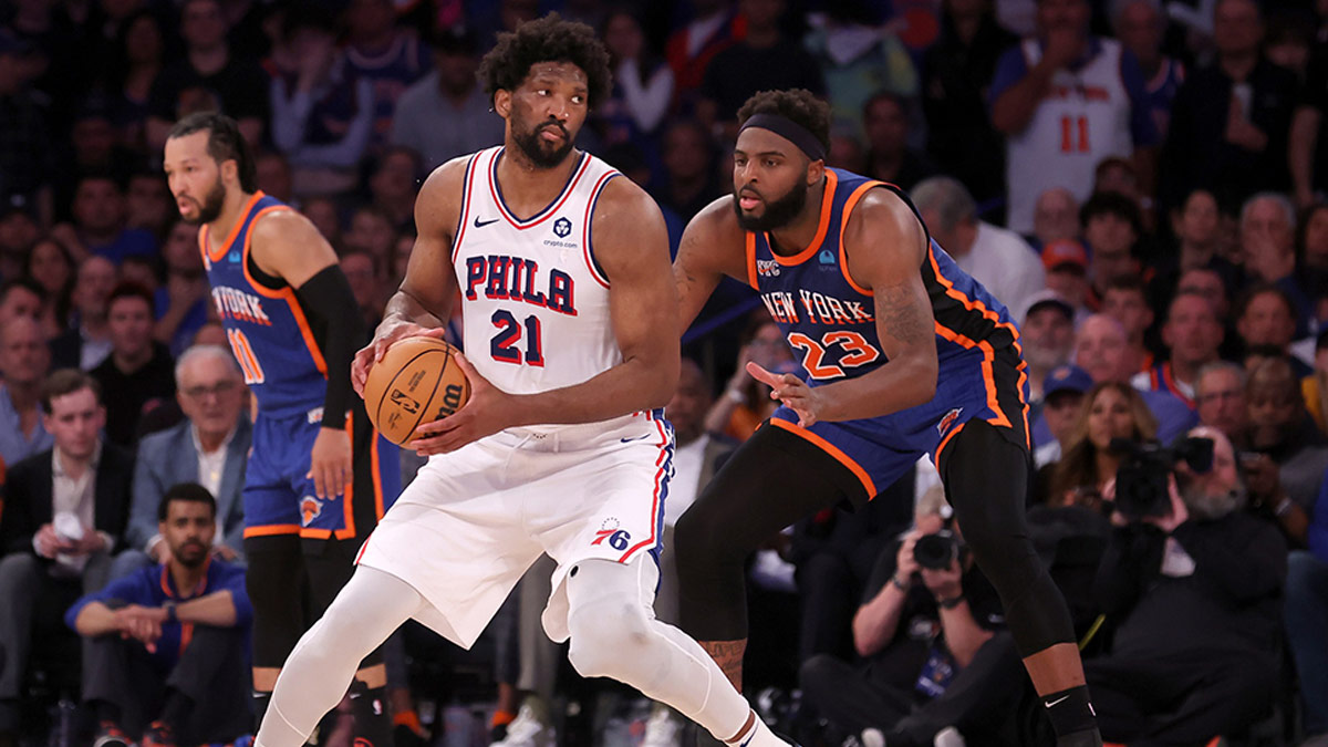 Philadelphia 76ers center Joel Embiid (21) passes the ball against New York Knicks center Mitchell Robinson (23) during overtime in Game 5 of the first round of the 2024 NBA Playoffs at Madison Square Garden. 