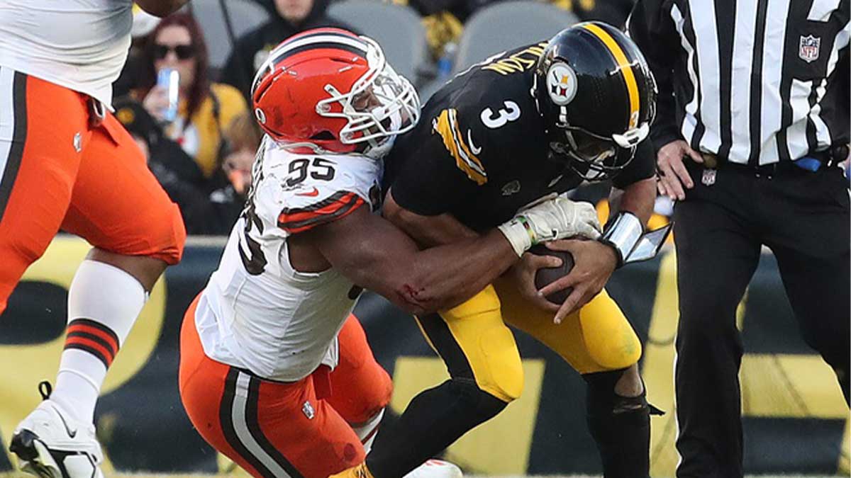 Cleveland Browns defensive end Myles Garrett (95) sacks Pittsburgh Steelers quarterback Russell Wilson (3) during the fourth quarter at Acrisure Stadium.