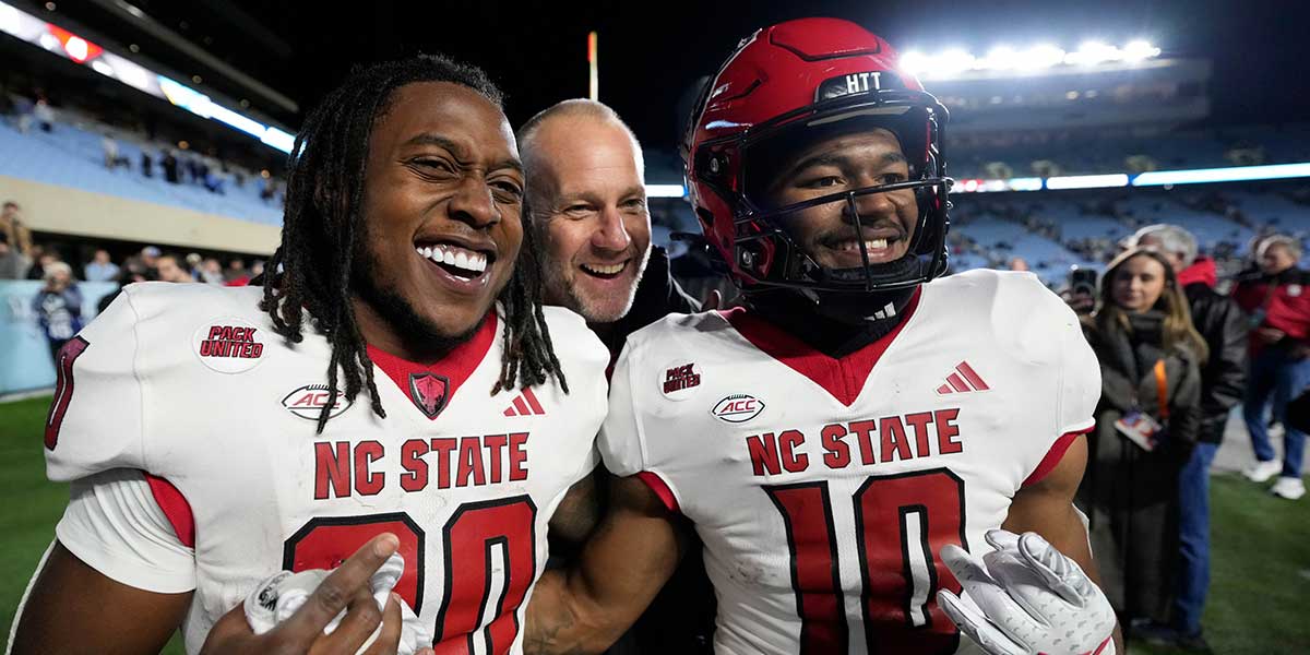 North Carolina State Wolfpack head coach Dave Doreren celebrates with North Carolina State Wolfpack running back Hollywood Smothers (20) and wide receiver Kevin Concepcion (10) after the game at Kenan Memorial Stadium