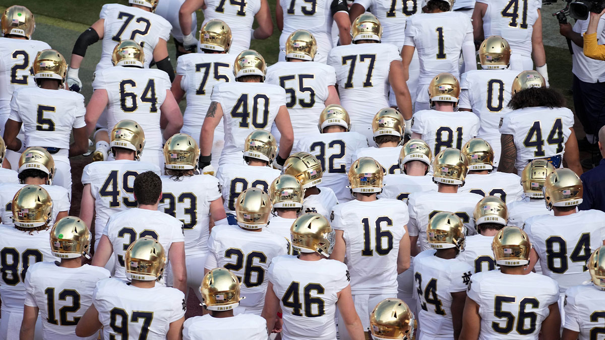 Nov 30, 2024; Los Angeles, California, USA; Notre Dame Fighting Irish players enter the field wearing gold helmets during the game against the Southern California Trojans at United Airlines Field at Los Angeles Memorial Coliseum. Mandatory Credit: Kirby Lee-Imagn Images