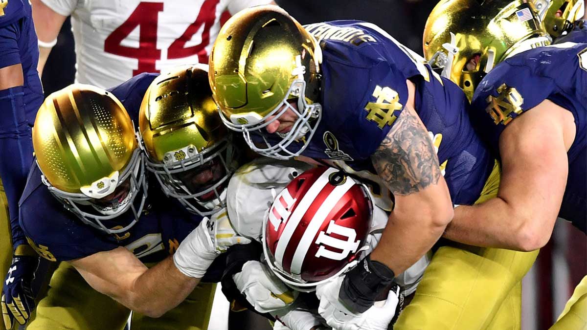 Notre Dame Fighting Irish defensive lineman Joshua Burnham (40) and teammates tackle Indiana Hoosiers wide receiver Myles Price (4) during the third quarter at Notre Dame Stadium.