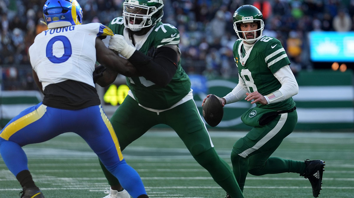 New York Jets quarterback Aaron Rodgers (8) looks for an open receiver late in the first half, Sunday, December 22, 2024, in East Rutherford.