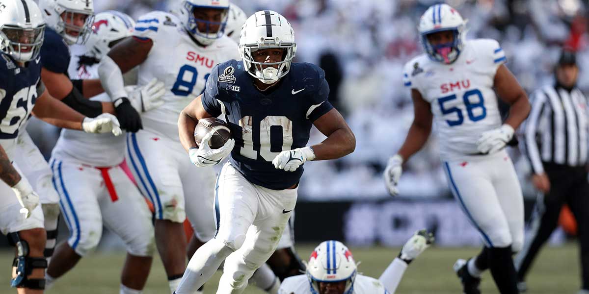 Penn State Nittany Lions running back Nicholas Singleton (10) breaks a tackle while running with the ball during the fourth quarter against the Southern Methodist Mustangs in the first round of the College Football Playoff at Beaver Stadium.