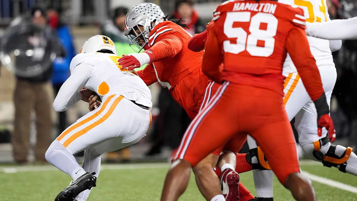Tennessee quarterback Nico Iamaleava (8) is sacked by Ohio State defensive edge JT Tuimoloau (44) during a College Football Playoff first round game between Tennessee and Ohio State held at Ohio Stadium in Columbus, Ohio, Saturday, Dec. 21, 2024.