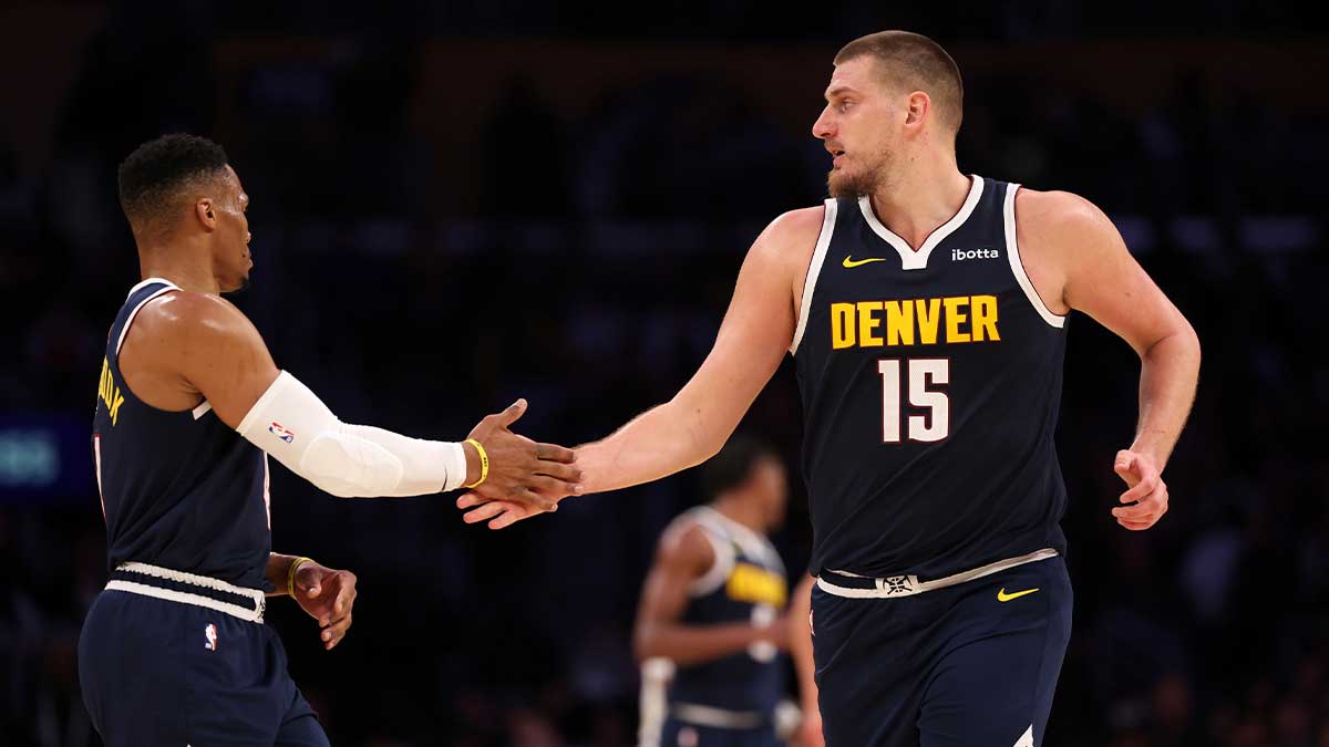 Denver Nuggets center Nikola Jokic (15) embraces guard Russell Westbrook (4) during the third quarter against the Los Angeles Lakers at Crypto.com Arena.