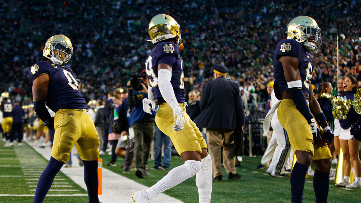 Notre Dame safety Xavier Watts (0), cornerback Christian Gray (29) and safety Adon Shuler (8) celebrate a Watts interception during a NCAA college football game against Virginia