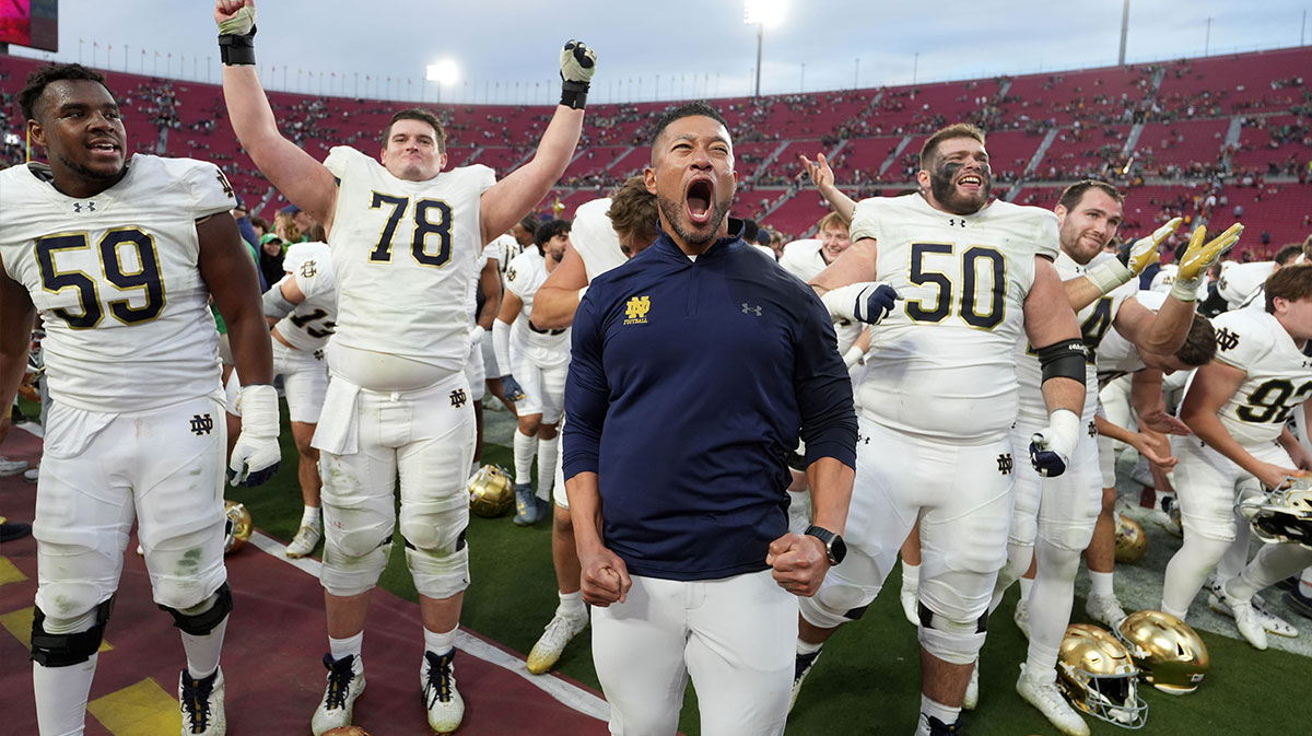 Notre Dame Fighting Irish head coach Marcus Freeman celebrates with players at the end of the game against the Southern California Trojans at United Airlines Field at Los Angeles Memorial Coliseum.