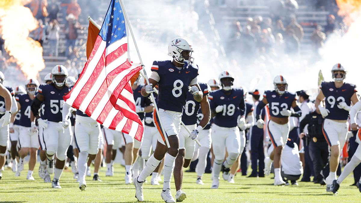 Virginia Cavaliers wide receiver Malachi Fields (8) carries the American flag onto the field prior to the Cavaliers’ game against the Southern Methodist Mustangs at Scott Stadium.
