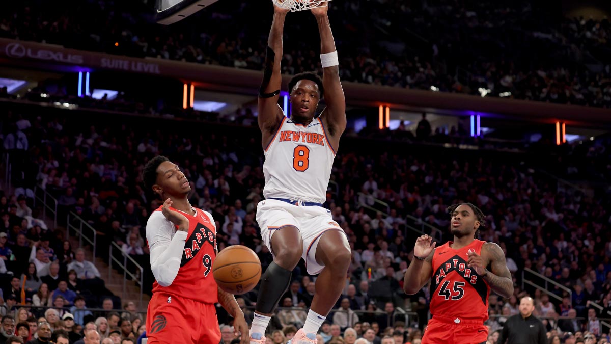 New York Knicks forward OG Anunoby (8) hangs on the sidelines after a dunk against Toronto Raptors guard RJ Barrett (9) and Davion Mitchell (45) in the third quarter at Madison Square Garden. 