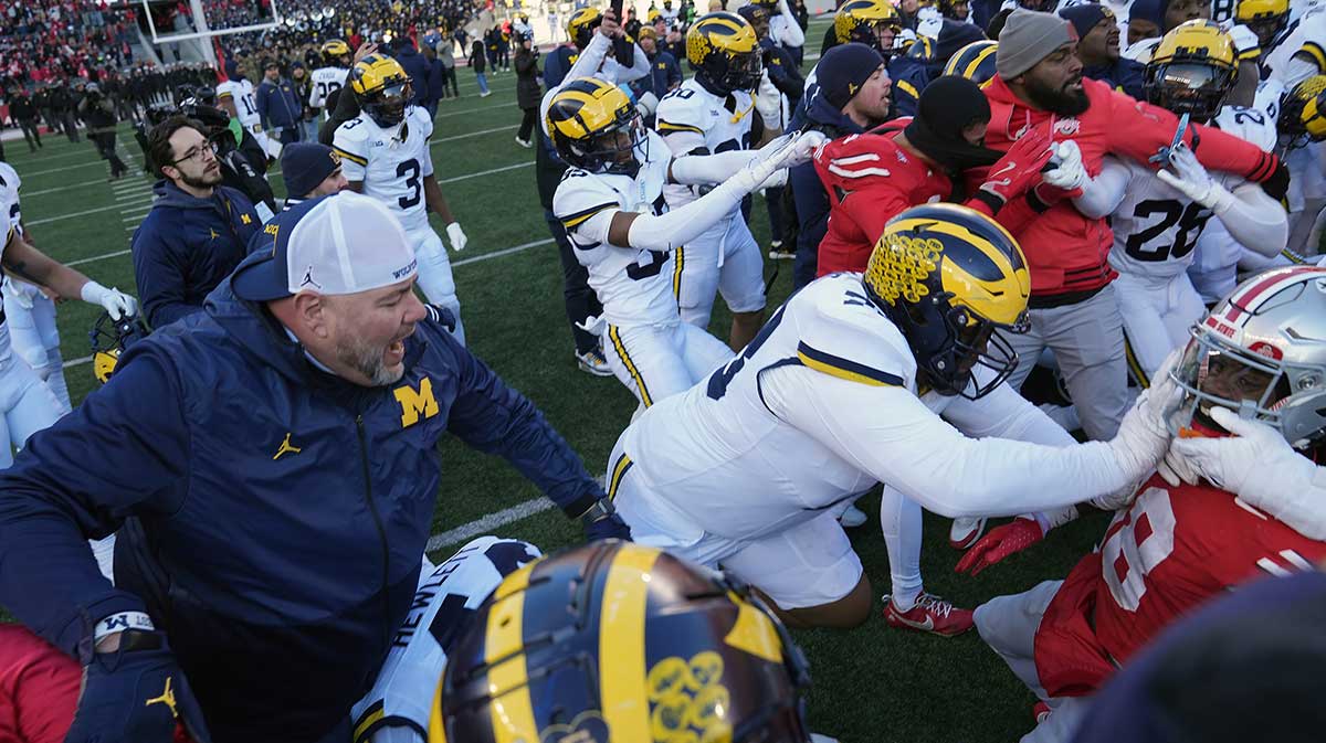 Michigan Wolverines defensive lineman Kenneth Grant (78) goes after Ohio State Buckeyes safety Jaylen McClain (18) after the game during a fight at the middle of the field after the NCAA football game at Ohio Stadium in Columbus on Saturday, Nov. 30, 2024.