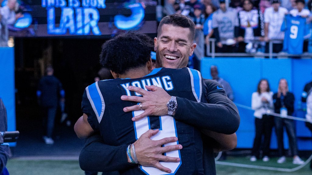 Carolina Panthers head coach Dave Canales hugs quarterback Bryce Young (9) after getting the win against the New Orleans Saints at Bank of America Stadium.