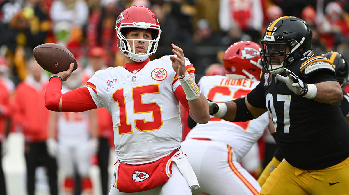 Dec 25, 2024; Pittsburgh, Pennsylvania, USA; Kansas City Chiefs quarterback Patrick Mahomes (15) throws a pass while being pressured by Pittsburgh Steelers defensive tackle Cameron Heyward (97) during the first quarter at Acrisure Stadium.