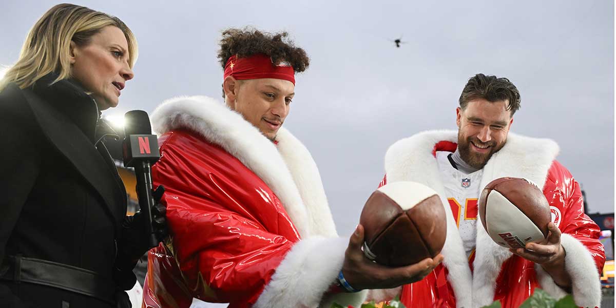 Kansas City Chiefs quarterback Patrick Mahomes (15) and tight end Travis Kelce (87) look at football cakes while being interviewed by Netflix reporter Stacey Dales following their win against the Pittsburgh Steelers at Acrisure Stadium.