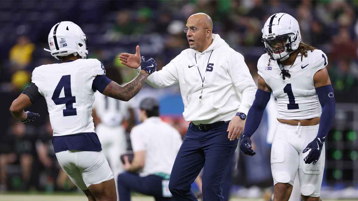 Penn State Nittany Lions wide receiver Tyseer Denmark (4) high-fives Penn State Nittany Lions head coach James Franklin during warmups prior to facing the Oregon Ducks in the 2024 Big Ten Championship game at Lucas Oil Stadium. 