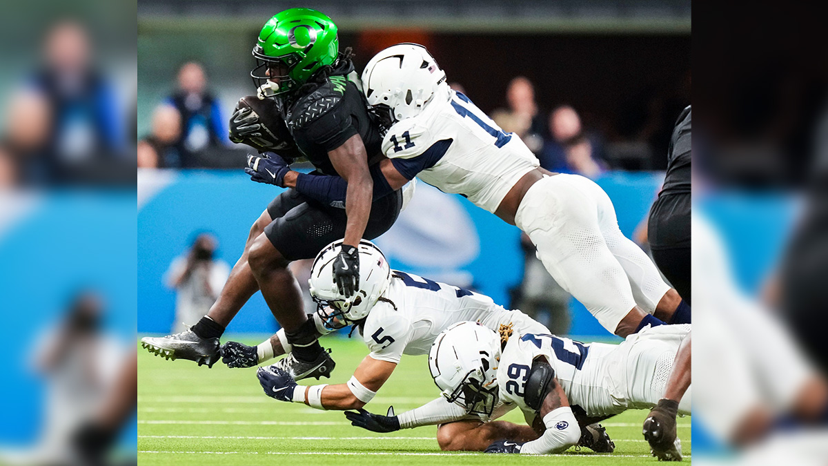 Oregon Ducks running back Noah Whittington (6) carries the ball Saturday, Dec. 7, 2024, during the Big Ten Championship game between the Oregon Ducks and the Penn State Nittany Lions at Lucas Oil Stadium in Indianapolis. The Ducks defeated the Nittany Lions, 45-37.