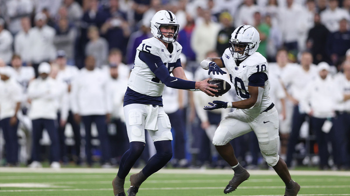Penn State Nittany Lions quarterback Drew Allar (15) hands off to running back Nicholas Singleton (10) against the Oregon Ducks during the second quarter in the 2024 Big Ten Championship game at Lucas Oil Stadium.