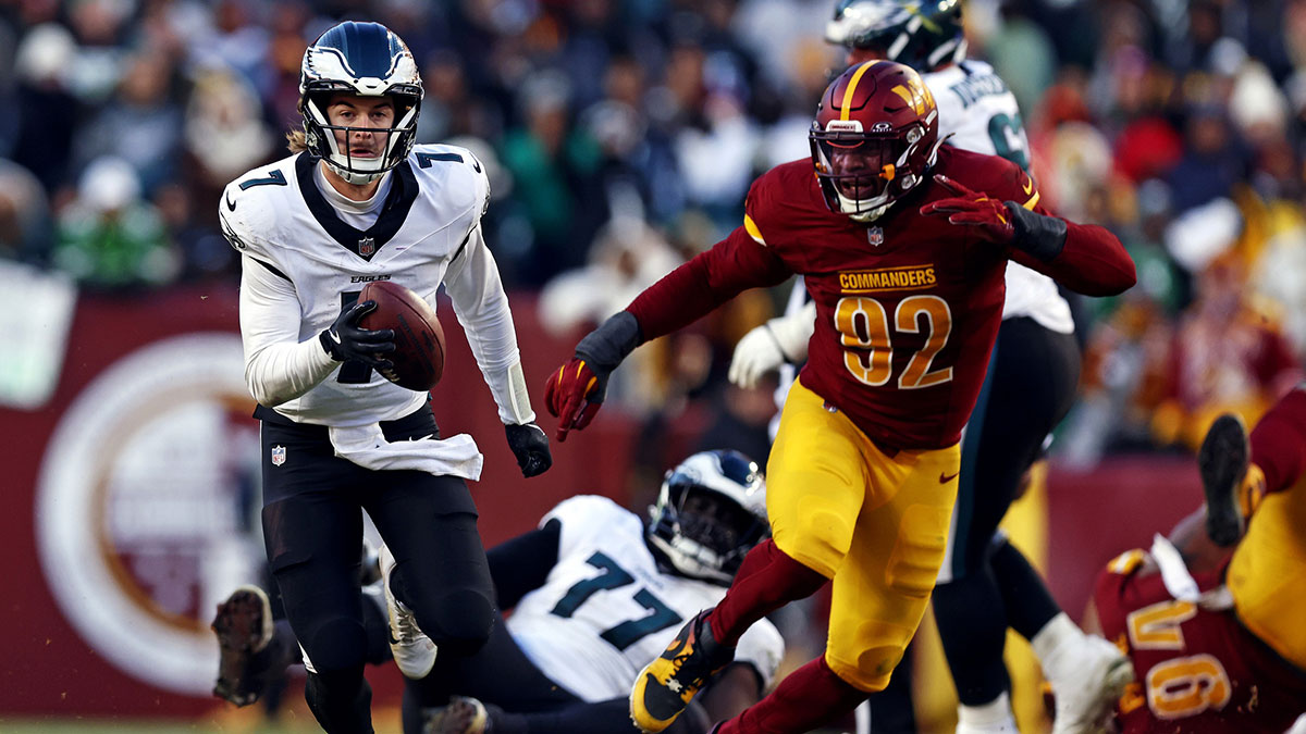 Philadelphia Eagles quarterback Kenny Pickett (7) runs the ball against Washington Commanders defensive end Dorance Armstrong (92) during the third quarter at Northwest Stadium.