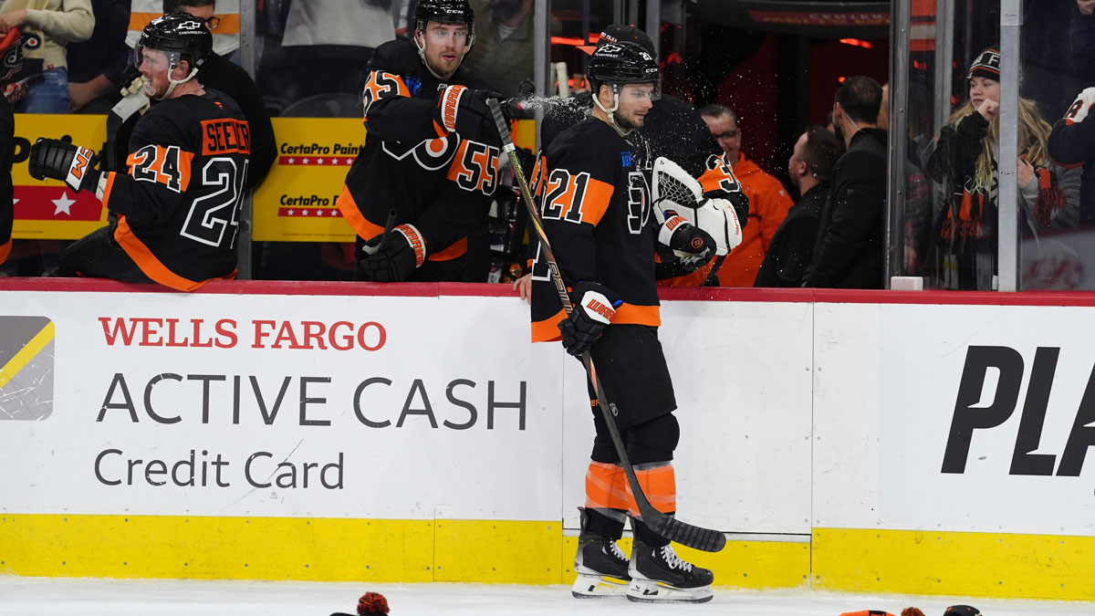 Philadelphia Flyers defenseman Rasmus Ristolainen (55) sprays center Scott Laughton (21) after he scored a hat-trick goal against the Detroit Red Wings in the third period at Wells Fargo Center.