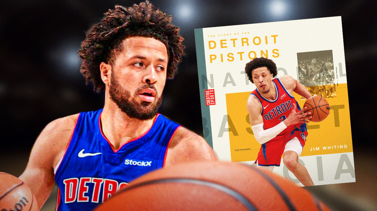 Cade Cunningham next to a big Pistons Record Book