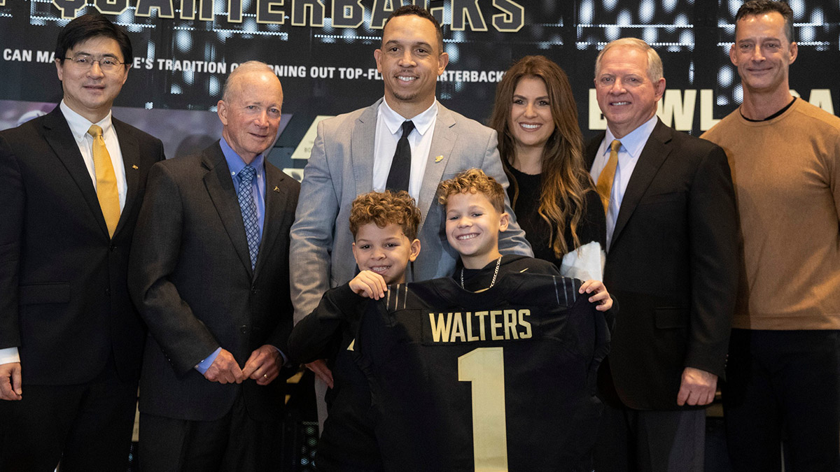 Purdue football head coach Ryan Walters poses for a photo with family and members of Purdue during a press conference introducing him as the new head coach, Wednesday, Dec. 14, 2022, at the Kozuch Football Performance Complex in West Lafayette, Ind.