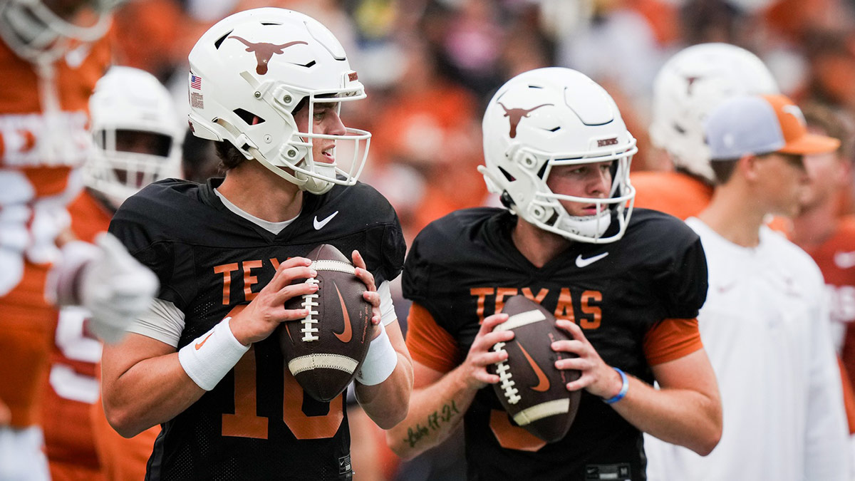 Texas football quarterbacks Arch Manning (16), left, and Quinn Ewers (3) throw passes while warming up ahead of the Longhorns' spring Orange and White game at Darrell K Royal Texas Memorial Stadium.