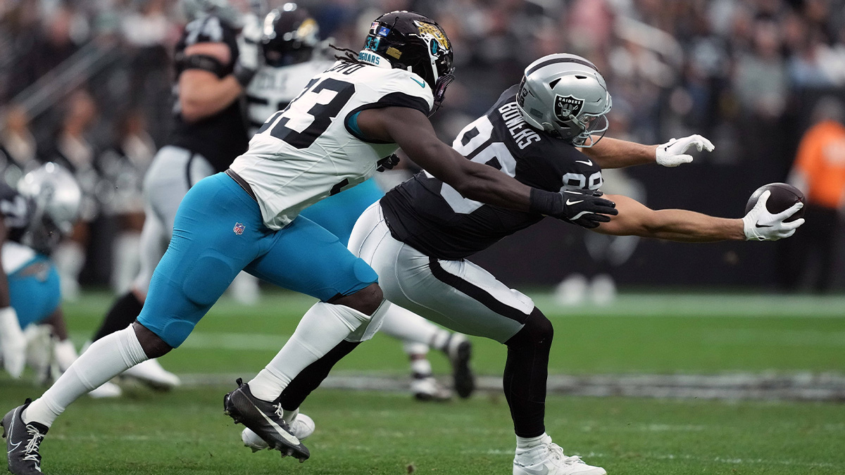 Las Vegas Raiders tight end Brock Bowers (89) makes a catch against Jacksonville Jaguars linebacker Devin Lloyd (33) in the first half at Allegiant Stadium.
