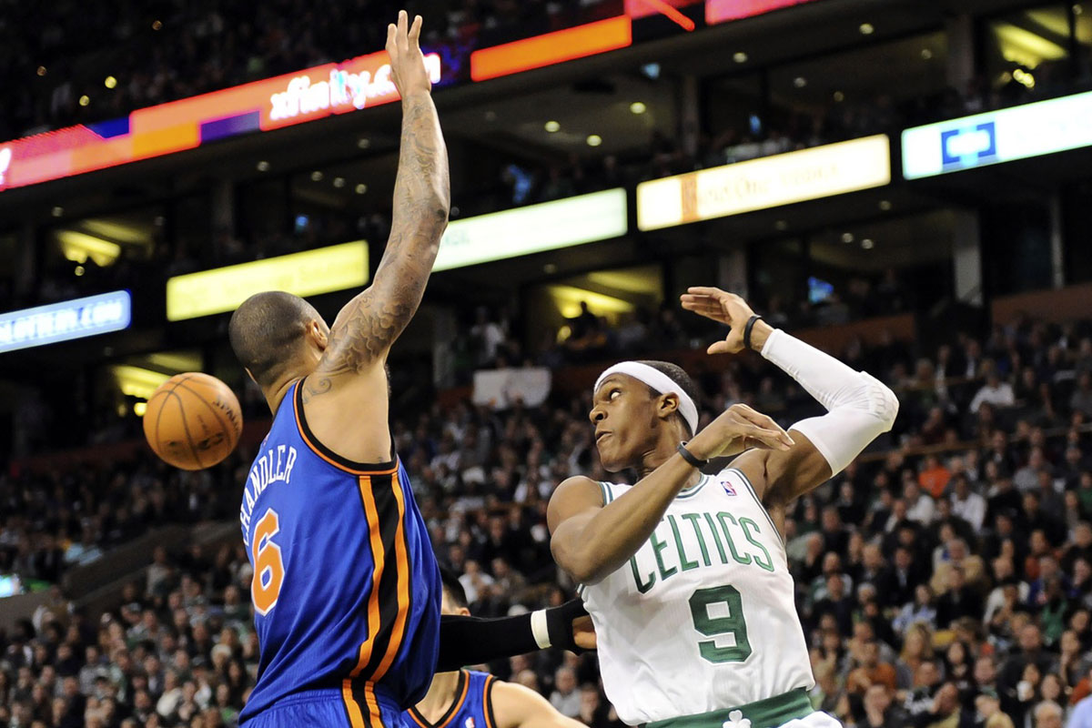 Boston Celtics point guard Rajon Rondo (9) passes the ball behind his back during the third quarter against the New York Knicks at TD Garden.