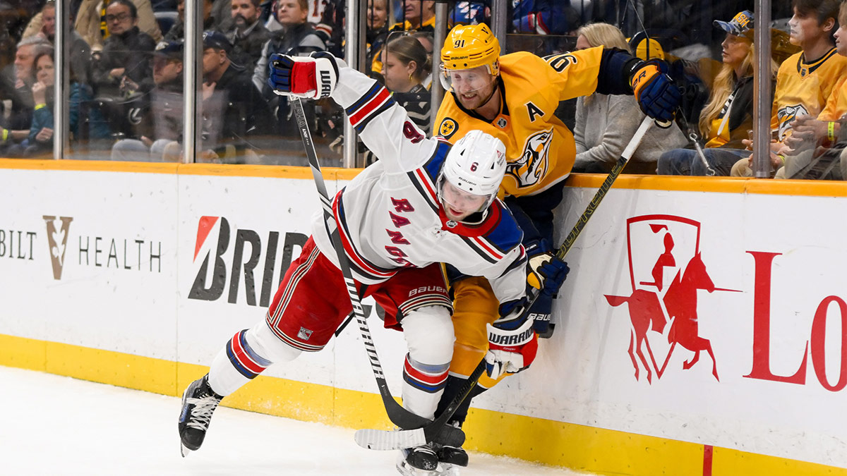 New York Rangers defenseman Zac Jones (6) and Nashville Predators center Steven Stamkos (91) battle for the puck during the third period at Bridgestone Arena.
