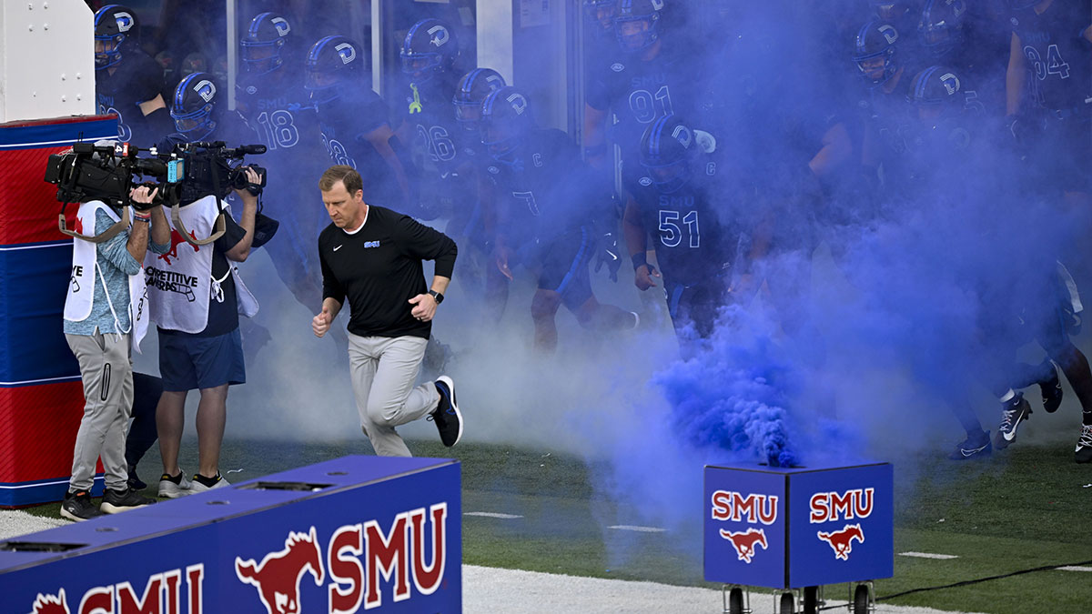 SMU Mustangs head coach Rhett Lashlee leads his team on to the field before the game between the SMU Mustangs and the Boston College Eagles at Gerald J. Ford Stadium.