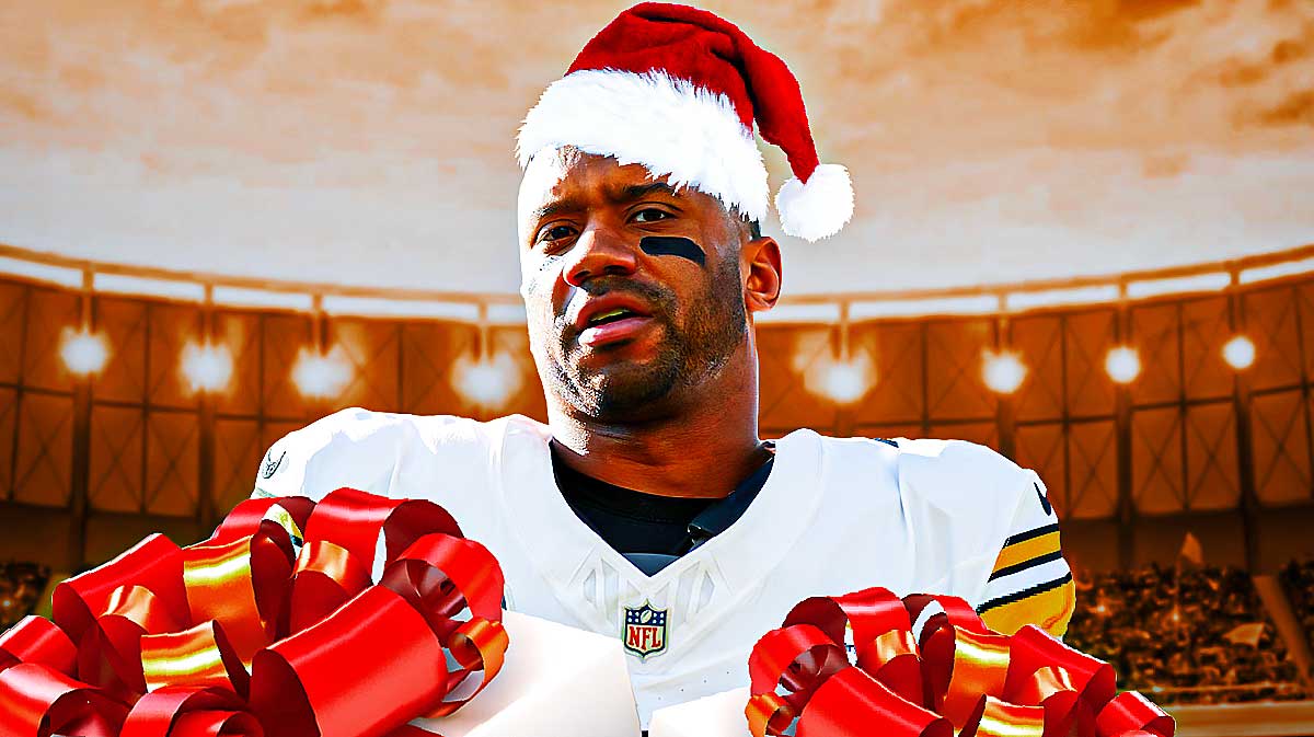Russell Wilson with a Christmas hat on and Christmas gifts surrounding him.