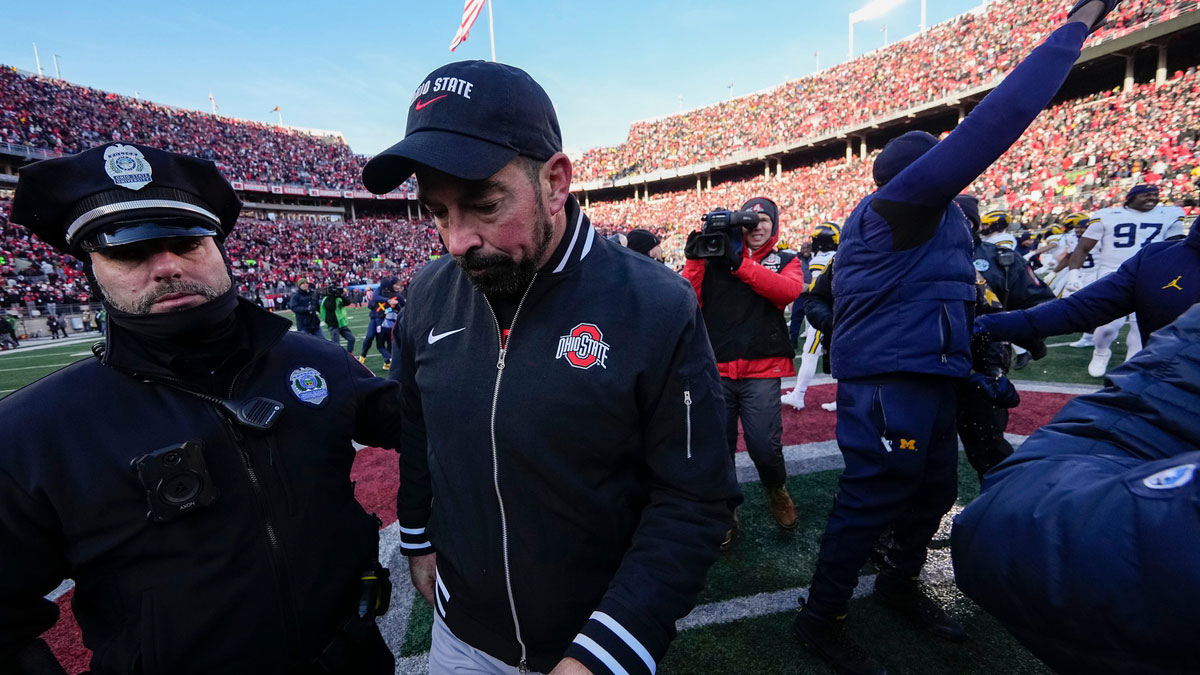 Ohio State Buckeyes head coach Ryan Day leaves the field shaking hands with Michigan Wolverines head coach Sherrone Moore, right, following the NCAA football game at Ohio Stadium in Columbus on Saturday, Nov. 30, 2024. Michigan won 13-10.