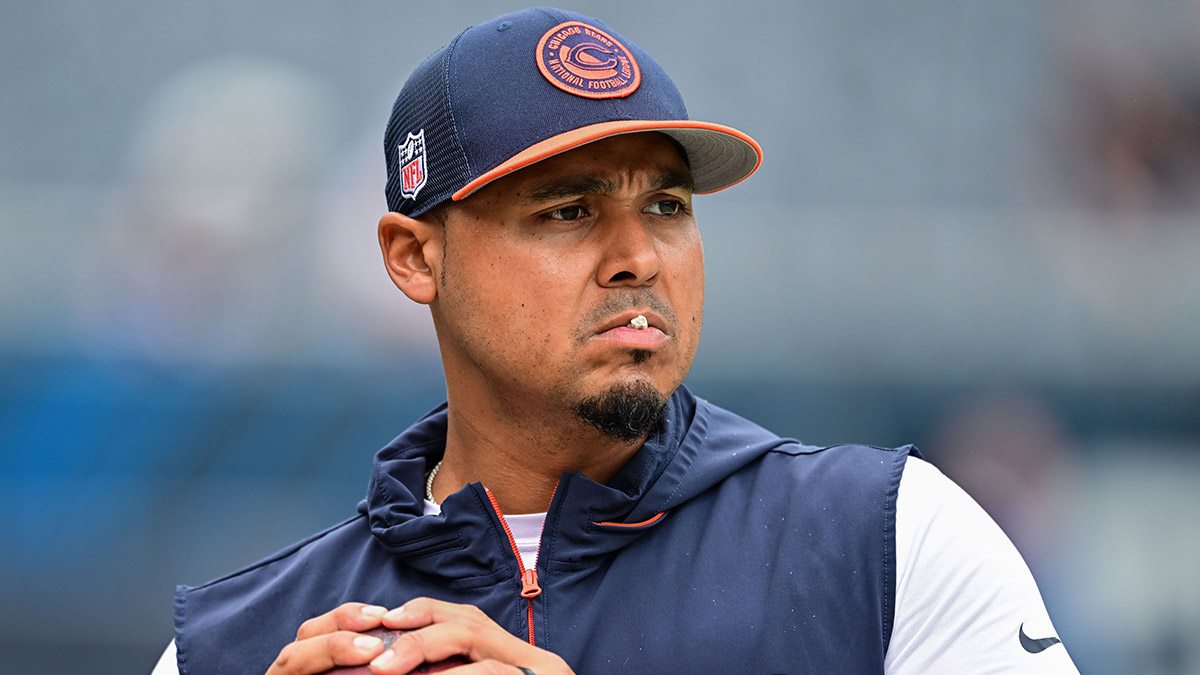 Chicago Bears general manager Ryan Poles plays catch on the sideline before the game against the Cincinnati Bengals at Soldier Field.