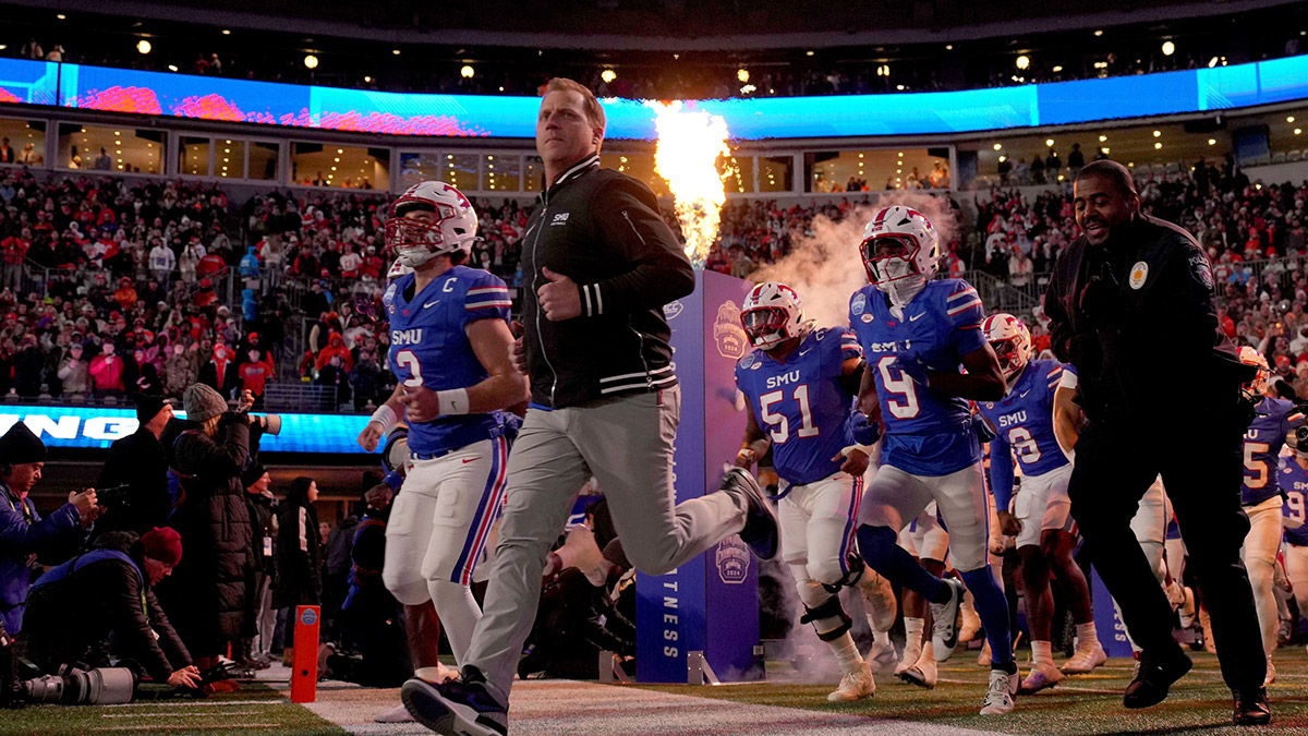 Southern Methodist Mustangs head coach Rhett Lashlee leads his team to the field before the 2024 ACC Championship game against the Clemson Tigers at Bank of America Stadium.