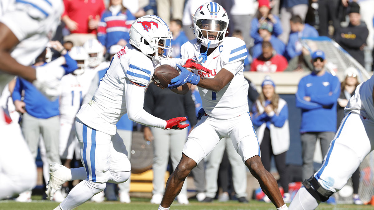 Southern Methodist Mustangs quarterback Kevin Jennings (7) hands the ball to Mustangs running back Brashard Smith (1) to score a touchdown against the Virginia Cavaliers during the first half at Scott Stadium.