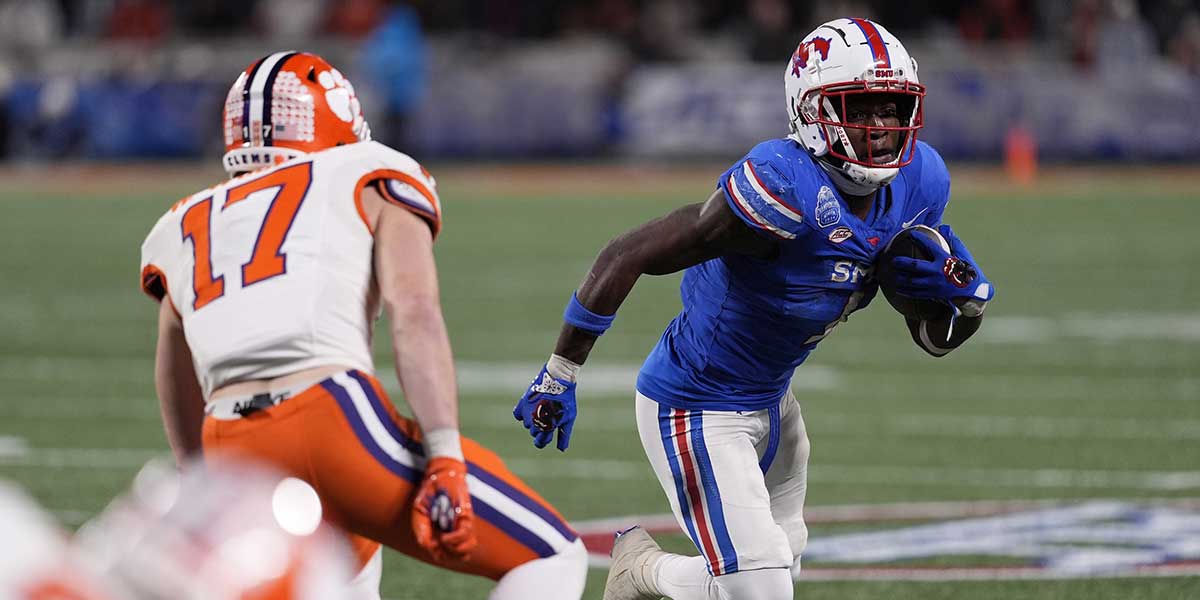 Southern Methodist Mustangs SMU Football running back Brashard Smith (1) runs against Clemson Tigers linebacker Wade Woodaz (17) during the fourth quarter in the 2024 ACC Championship game at Bank of America Stadium