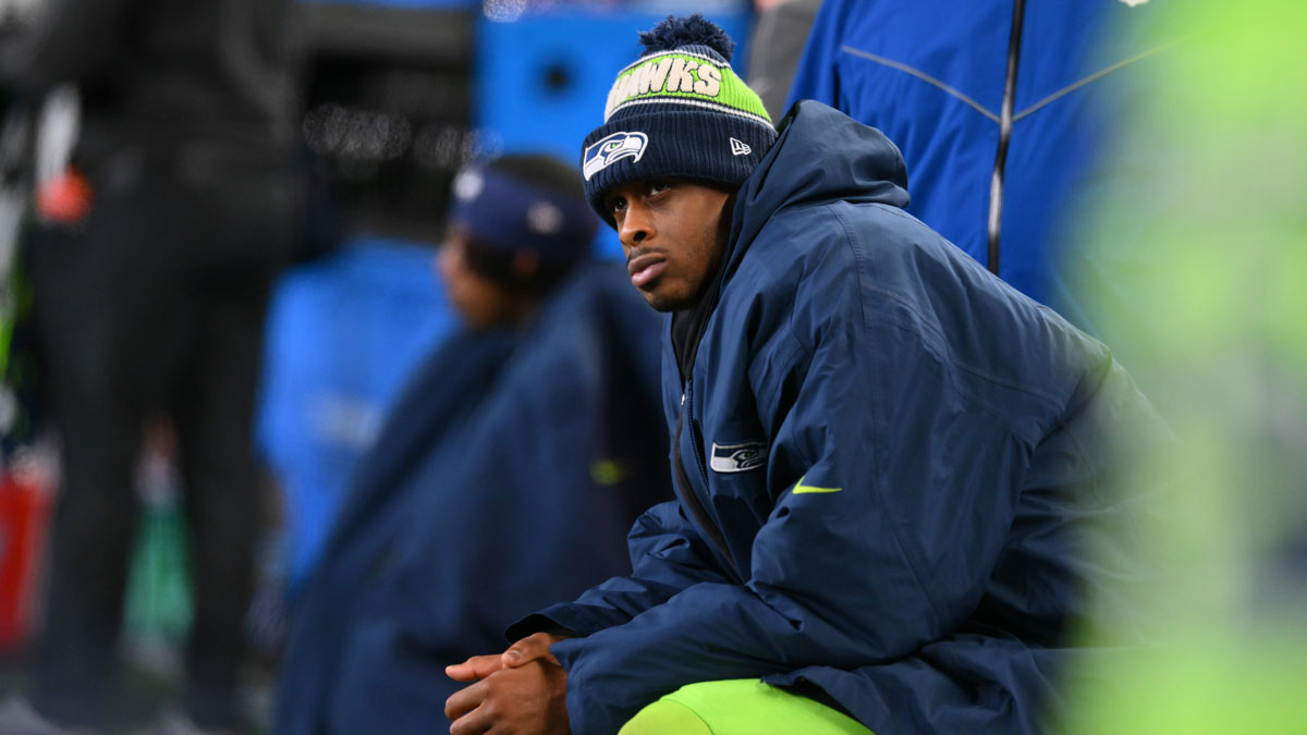 Seattle Seahawks quarterback Geno Smith (7) sits on the bench after an injury during the second half against the Green Bay Packers at Lumen Field.
