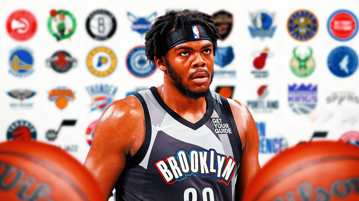 Day'Ron Sharpe with the NBA team logos behind him
