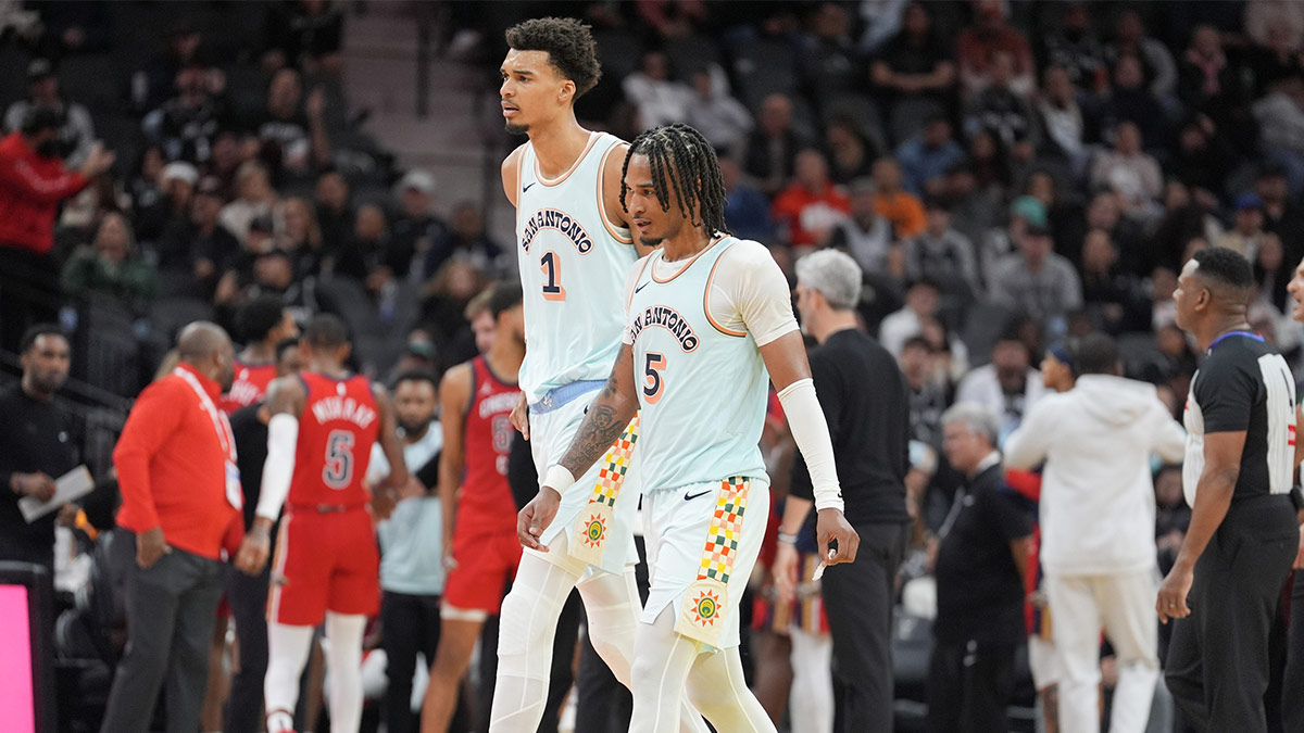 Dec 8, 2024; San Antonio, Texas, USA; San Antonio Spurs center Victor Wembanyama (1) and guard Stephon Castle (5) walk toward the bench in the second half against the New Orleans Pelicans at Frost Bank Center. Mandatory Credit: Daniel Dunn-Imagn Images
